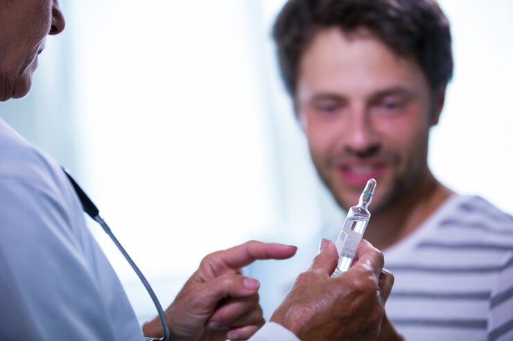 doctor-showing-injection-patient_1170-2123